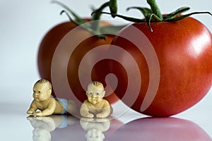 Miniature babies with tomatoes