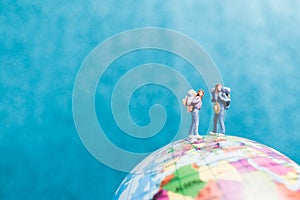 Miniature Backpacker , Travelers with backpack standing on world map
