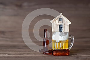 Miniature beer bottles and mug with a house on top