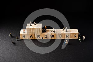 Miniature Builder Figures around Wooden Blocks with â€œHARDWORKâ€ wordings