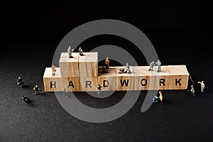 Miniature Builder Figures around Wooden Blocks with â€œHARDWORKâ€ wordings