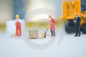 Miniature business man look workers carrying products. Cargo and shipping concept