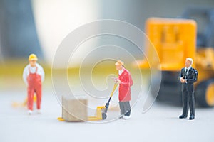 Miniature business man look workers carrying products. Cargo and shipping concept