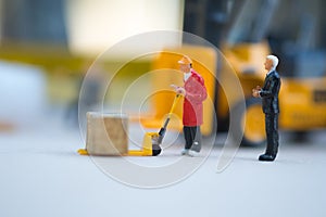 Miniature business man look workers carrying products. Cargo and shipping concept