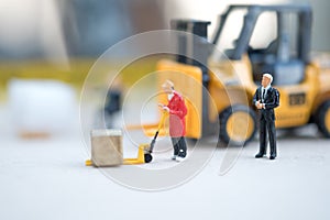 Miniature business man look workers carrying products. Cargo and shipping concept