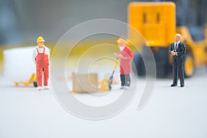 Miniature business man look workers carrying products. Cargo and shipping concept