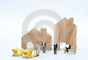 The miniature business man with Worker carry the Gold to buy building and Land isolate on white background Investiment  Concept photo