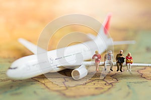 Miniature business people : businesses team waiting for airplane with copy space for travel around the world, business trip travel