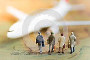 Miniature business people : businesses team waiting for plane on world map using as background travel