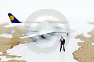 Miniature business people : businessman with plane. Image use for business travel, business trip travel advisory agency