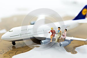 Miniature business people : businessman with plane. Image use for business travel, business trip travel advisory agency