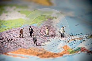 Miniature business people on top of US map. Business concept. Co