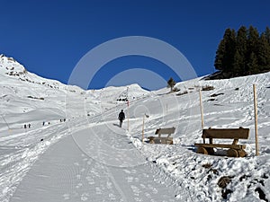 A miniature cemetery covered with fresh snow next to Arosa\'s mountain chapel (Das Bergkirchli Arosa)