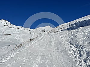 A miniature cemetery covered with fresh snow next to Arosa\'s mountain chapel (Das Bergkirchli Arosa)