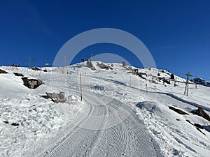 A miniature cemetery covered with fresh snow next to Arosa\'s mountain chapel (Das Bergkirchli Arosa)