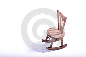 Miniature chair on wooden floor expressing lonely feeling and missing someone concept