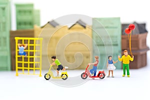 Miniature children: Boys cycling play fun in the playground. Image use for Children`s day