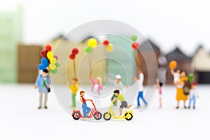 Miniature children: Boys cycling play fun in the playground. Image use for Children`s day