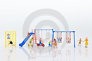 Miniature children: Group childrens are playing together on playground. Image use for Children`s Day.