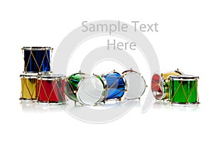 Miniature Christmas drums on white with copy space