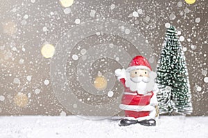 Miniature Christmas Santa cros and Tree on snow over blurred bokeh background,Decoration Image for Christmas Holiday and Happy New