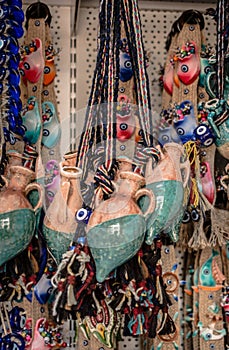 Miniature clay pitchers hanging in a store photo