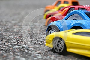 Miniature colorful cars standing in line on road sale concept