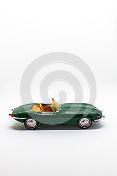 Miniature convertible green car isolated on a white background
