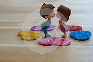 The Miniature Couple dolls Boy and Girl Romantic Kiss with Heart around the Ground  for Background for valentine`s Day Concept