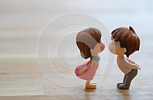 The Miniature Couple dolls Boy and Girl Romantic Kiss with Heart around the Ground  for Background for valentine`s Day Concept