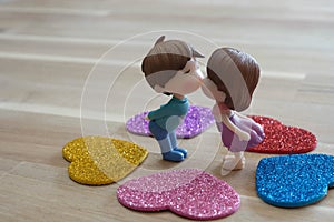 The Miniature Couple dolls Boy and Girl Romantic Kiss with Heart around the Ground  for Background for valentine`s Day Concept