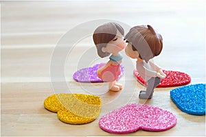 The Miniature Couple dolls Boy and Girl Romantic Kiss with Heart around the Ground  for Background for valentine`s Day Concept
