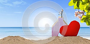 Miniature couple with red heart on tropical beach