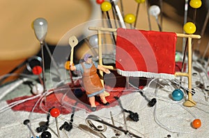 Miniature diorama: housewife beating carpet photo