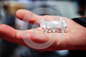 A miniature drone in hand