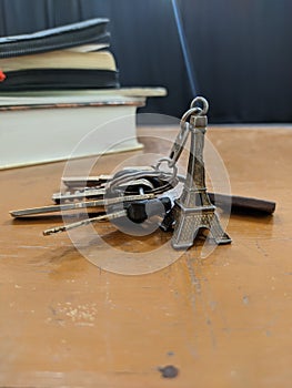 Miniature Eiffel tower key chain and some keys and books