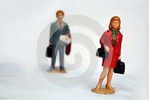 Miniature elegant woman and some man behind her, looking or follow the lady, stalking or sexual harassment concept, admirer,