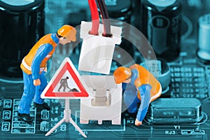 Miniature engineers fixing wire connector