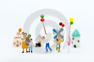 Miniature family: Childrens playing balloon together. Image use for background International day of families concept