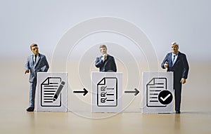 Miniature figure businessmen standing with white paper and document icon for prepare , check and approve document and project