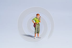 Miniature figure concept of woman use smartphone