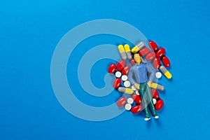 Miniature Figure, Pills, drugs on colorful background. Healthcare concept, Shallow depth of field, soft focus