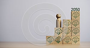 Miniature figure smile and standing on carbon reduction icon on wooden block cube for progressive of carbon credit footprint for