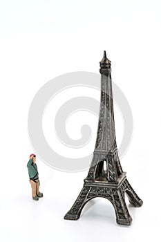 miniature figurine of an hiker looking at Eiffel Tower in Paris