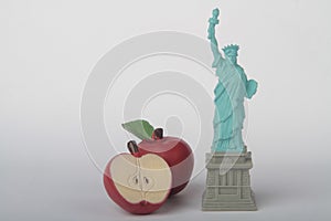 Miniature figurine of the Liberty statue with a big apple,  symbols of New York city