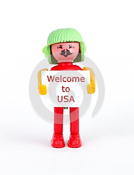 miniature figurine of a man holding paper with text welcome to