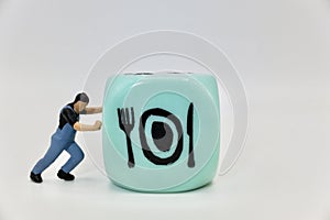 miniature figurine of a man pushing a restaurant symbol