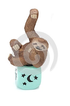 miniature figurine of a toy sloth with the moon and the stars