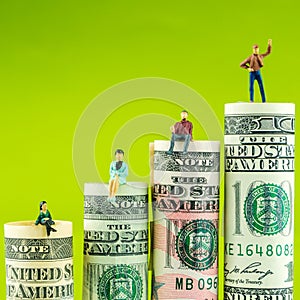 Miniature figurine with victory gesture on most valued american dollar banknote