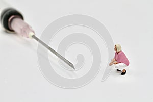 miniature figurine of a woman with a syringe